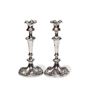 An Antique Sheffield plate pair of candlesticks with raised…