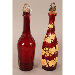 Two Victorian ruby glass decanters, of scalloped faceted form,…