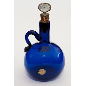 Two coloured glass decanters, one green with gilt mounts the…