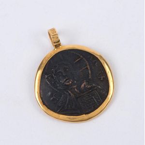 An antique bronze religious token set in 14ct gold pendant…