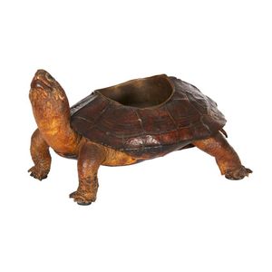 A taxidermy tortoise, the shell inset with a brass ashtray,…