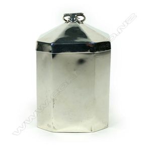 A silver tea caddy, pillarbox shape with scrolling hinged…