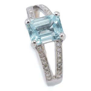 An 18ct white gold aquamarine and diamond ring, centring on an…