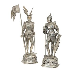 A pair of sterling silver and ivory figures of knights in…