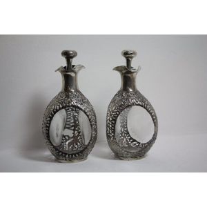 A pair of Continental silver embossed decanters, 25.5 cm high.