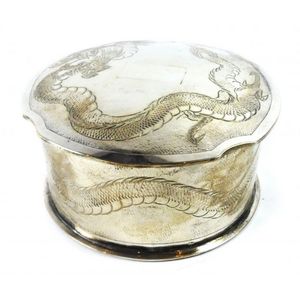 A small circular trinket box depicting an Asian styled dragon,…