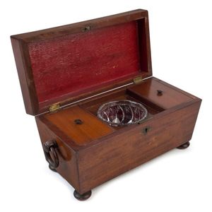 An antique English mahogany sarcophagus form tea caddy with…