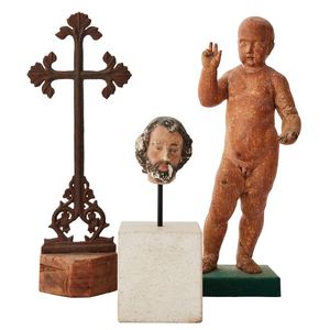 A carved wooden figure of the Christ child, a cast Iron Cross…