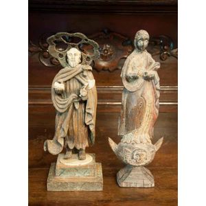 A carved wooden and ivory Santos figure and a carved wooden…