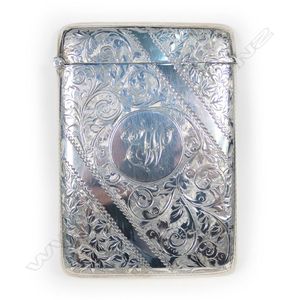 An Edwardian silver card case, the exterior profusely engraved,…