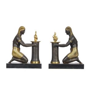 A pair of first Empire candlesticks, Darkly patinated and gilt…