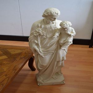 Antique cast iron statue of Saint David, holding a young child…