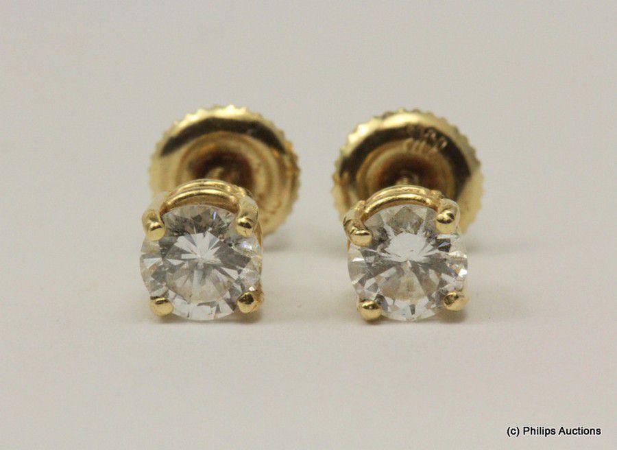 A pair of diamond solitaire studs totalling 0.82ct, 14ct yellow ...