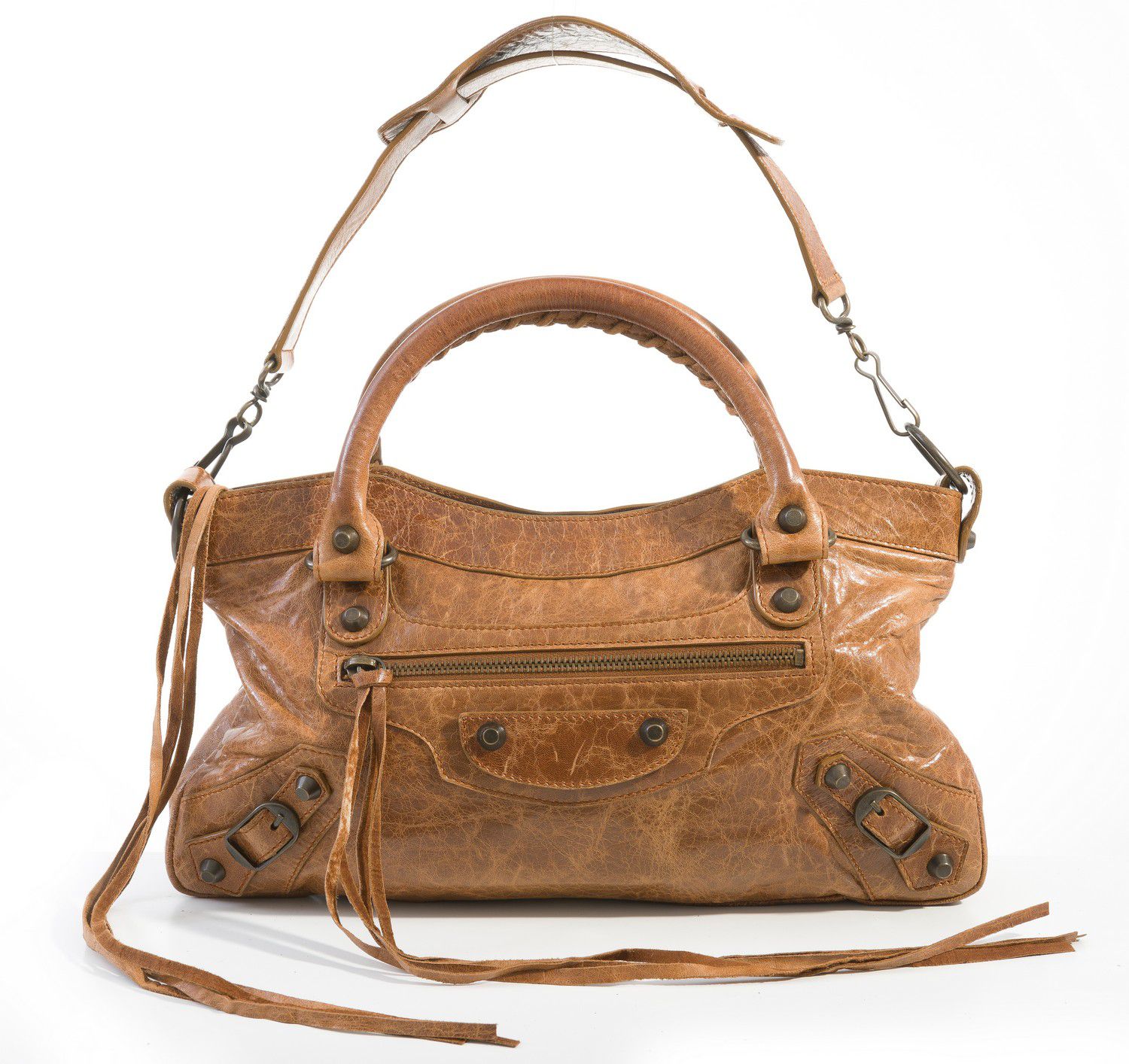 A handbag by Balenciaga, styled in distressed tan leather with ...