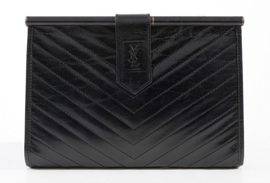 A clutch by Yves Saint Laurent, styled in quilted black leather ...