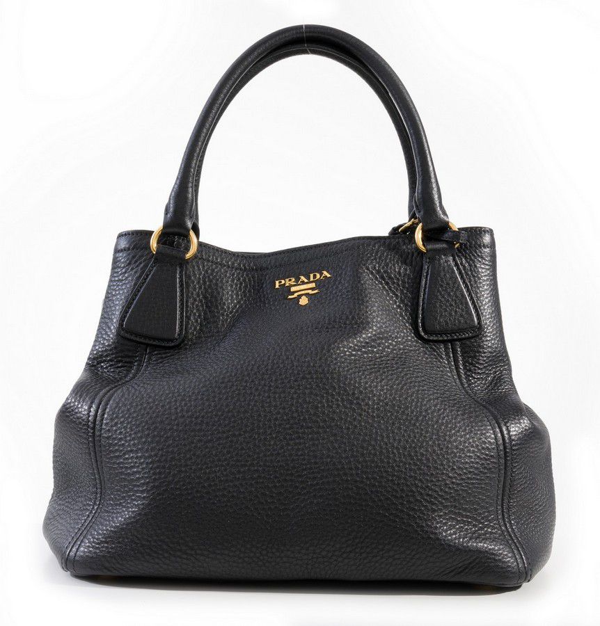 A handbag by Prada, styled in black leather with gold metal… - Handbags ...