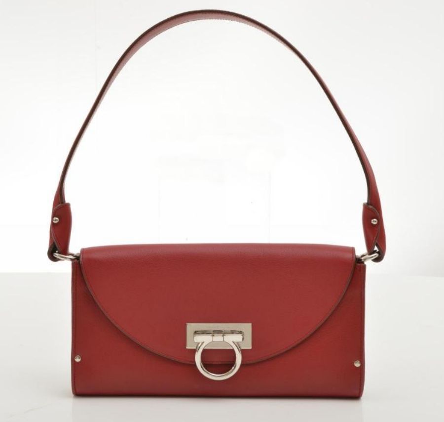 A handbag by Salvatore Ferragamo, styled in red leather with ...