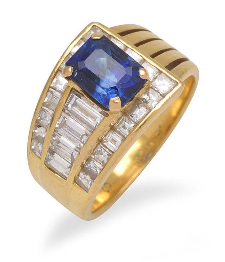 A sapphire and diamond ring, featuring an emerald cut sapphire… - Rings ...