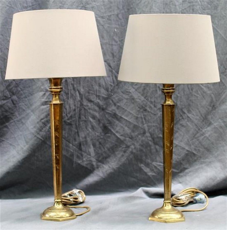 A pair of tall incised brass sub 