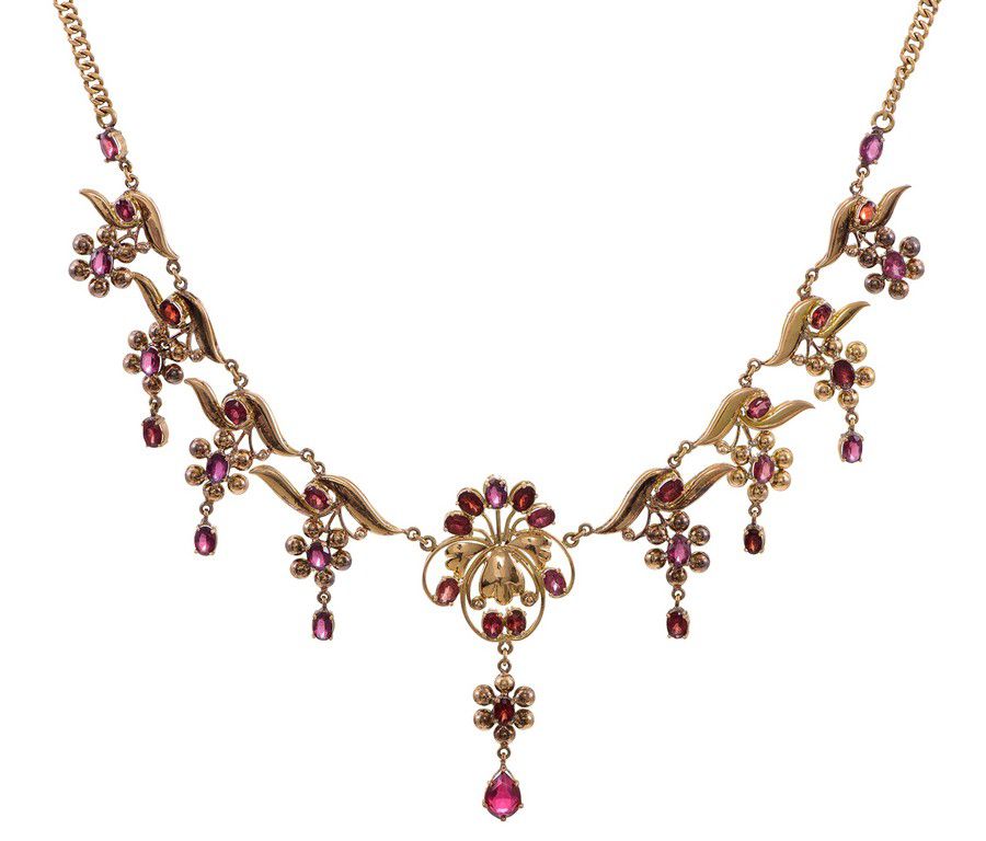 A garnet pendant necklace, of floral and foliate design, set ...