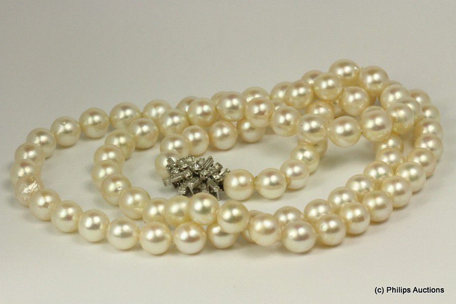 A strand of long cultured pearls with diamond clasp, 14ct white ...