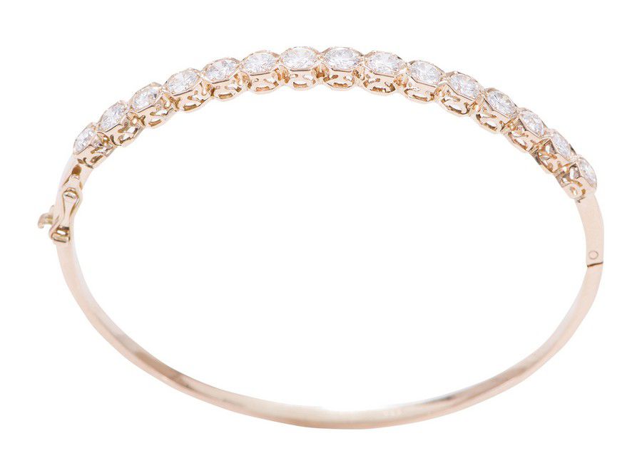 A diamond hinged bangle, comprising fifteen round brilliant cut ...
