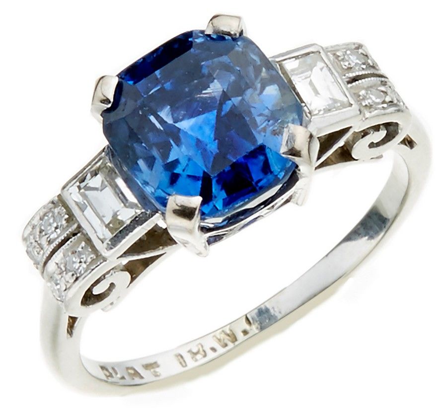 An Art Deco style sapphire and diamond ring, centrally set