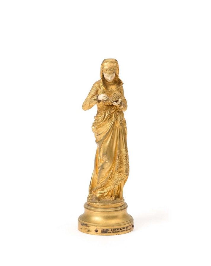 A gilt bronze and ivory figure of a lady reading a book, titled ...