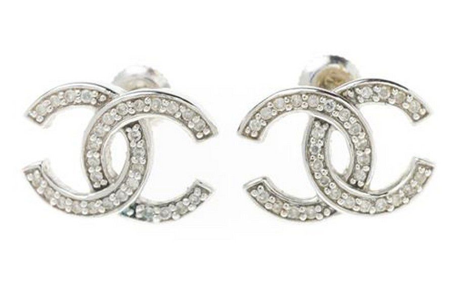 Sold at Auction A PAIR OF 18CT GOLD DIAMOND STUD EARRINGS crossed Cs in  the style of Chanel set with a total of 40 round brilliant cut diamonds  s