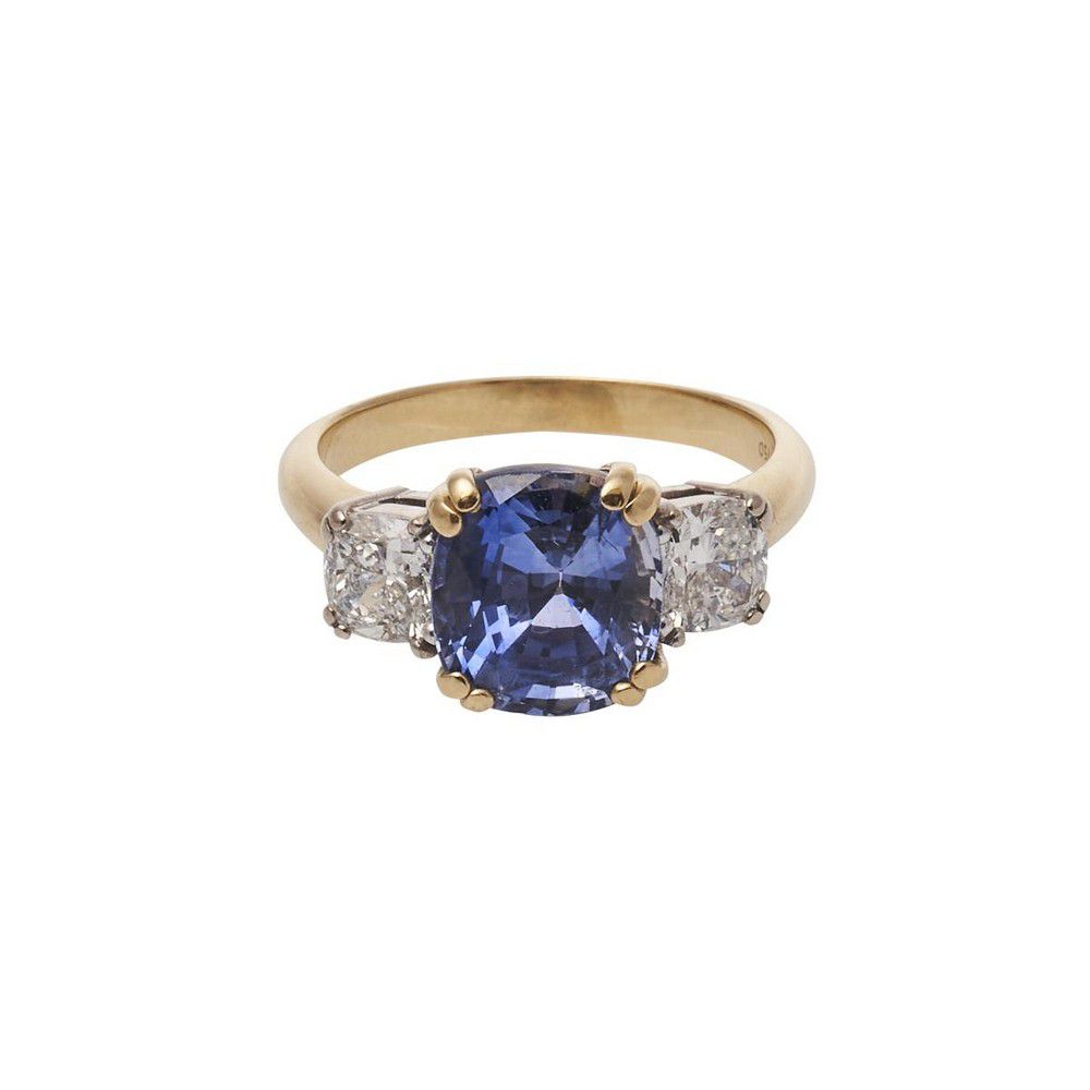 A sapphire and diamond ring, featuring one claw set cushion cut ...