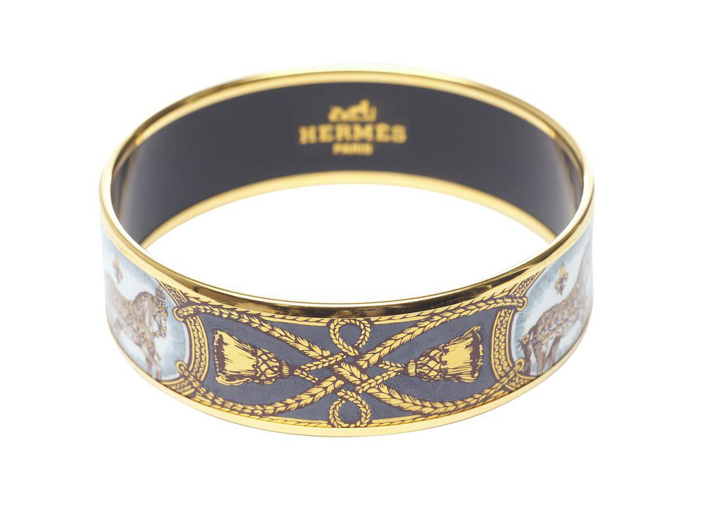 An enamel bangle by Hermes, styled with a 'Horse and carriage ...