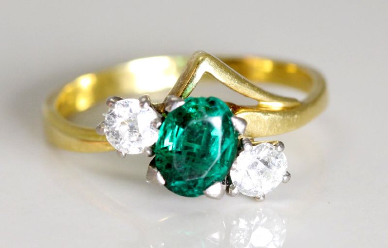 A three stone emerald and diamond ring. An 18ct yellow gold… - Rings ...