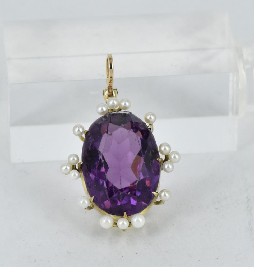 An amethyst and pearl pendant, oval cut amethyst of approx. 19 ...