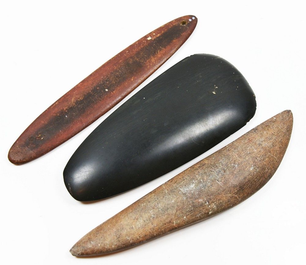 Aboriginal artist unknown, a carved black stone axe head, and ...