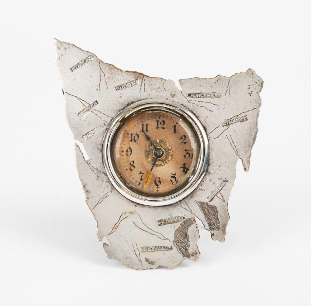 An antique silver plated map of Tasmania framed table clock,… Clocks