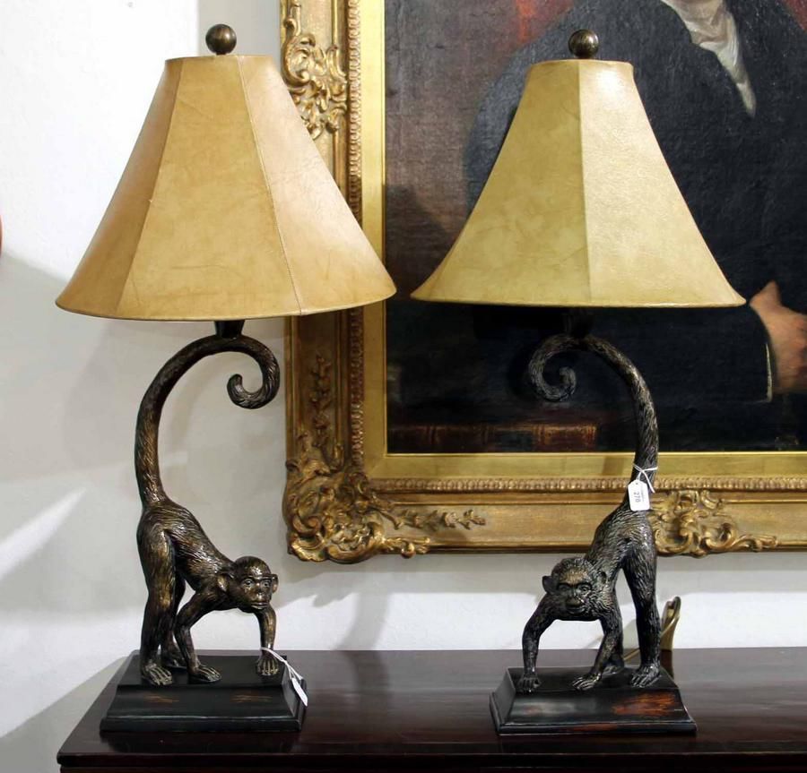 A pair of decorative monkey table lamps with cast metal monkeys