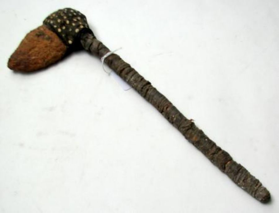 An Aboriginal stone axe with old original binding and spinifex